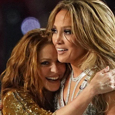 Shakira, left, and Jennifer Lopez embrace after pe