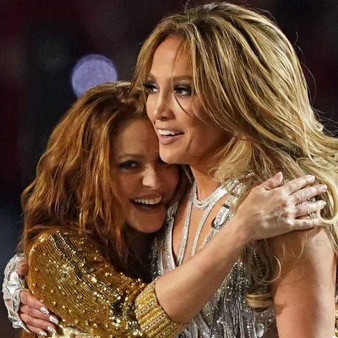 Shakira, left, and Jennifer Lopez embrace after pe
