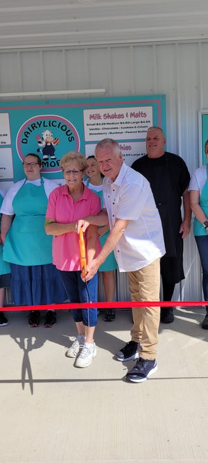 Linda and Mike Meeks, owners of the new Dairylicious restaurant in Loudonville, cut the ribbon for their new business Friday morning, June 10. In addition to sandwiches and ice cream, Dairylicious offers a game room for visitors at its location on the state Route 3 bypass on the southwest side of Loudonville.