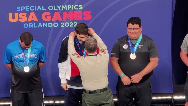 Nicholas Zellin receiving his gold medal for the 25-yard freestyle at the Special Olympics USA Games on Tuesday, June 7, 2022 in Orlando, Florida.