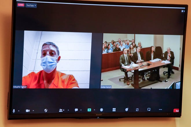 GRPD Officer Christopher Schurr, left, seen here remotely from Calhoun County jail with his legal team on the right, is arraigned in 61st District Court in Grand Rapids on June 10, 2022. Schurr is charged with second degree murder of Patrick Lyoya.  