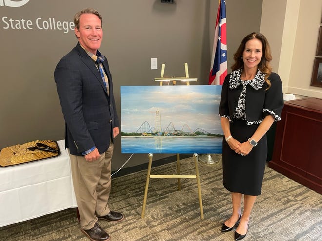 Tina Husted and her husband, Ohio Lieutenant Governor Jon Husted, stand by the Cedar Sky painting by Mrs. Husted.