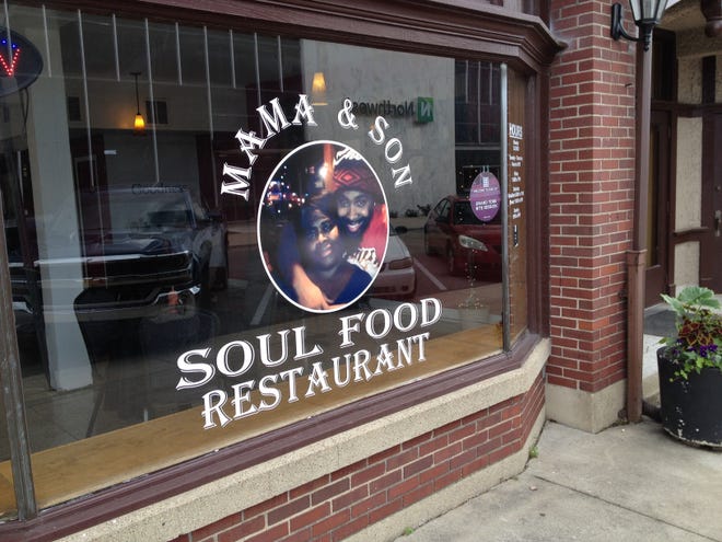 The front window of the Mama and Son Soul Food Restaurant looks out on Charles Street in downtown Muncie.