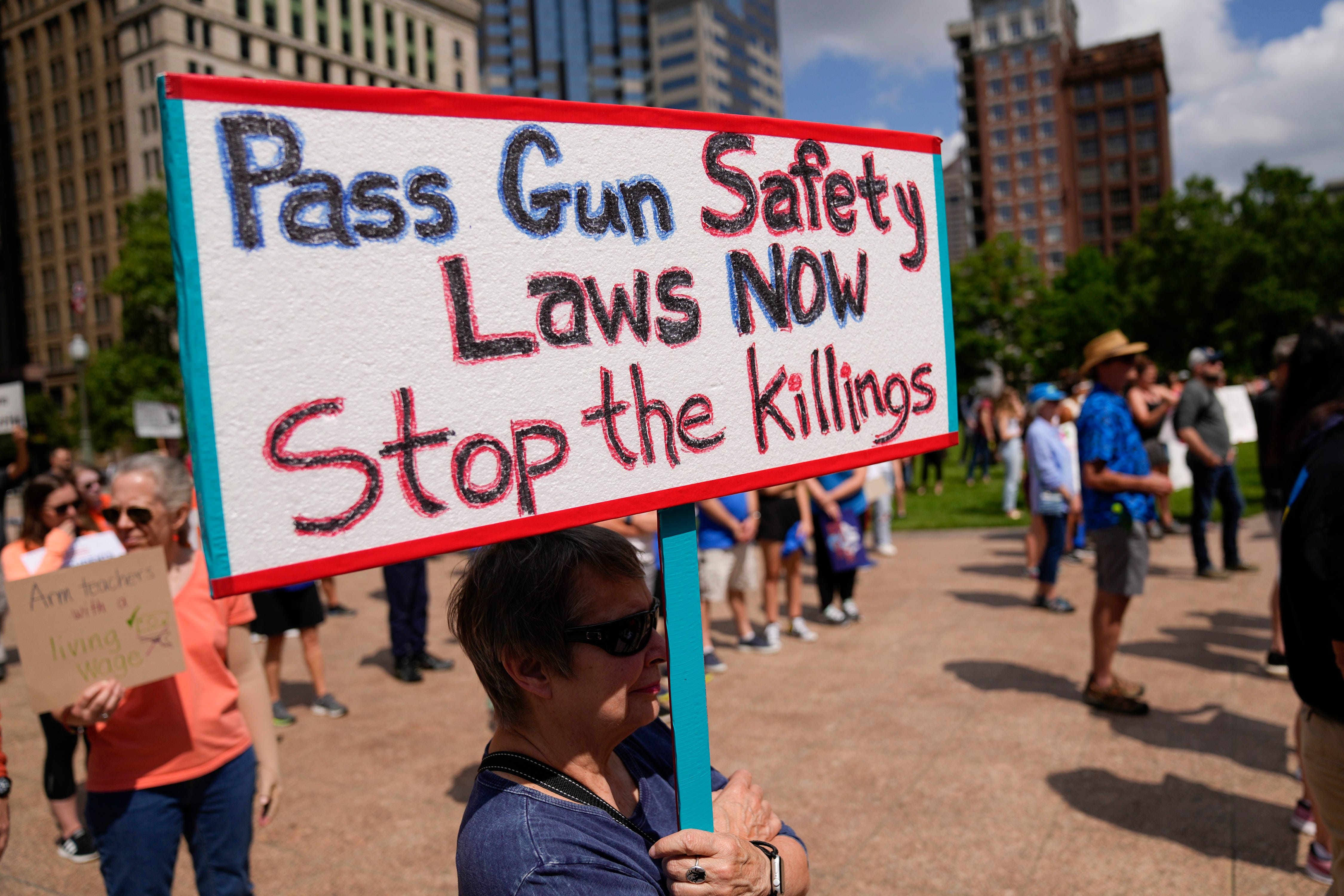 Niki Hird, of Clintonville, holds a sign encouraging gun safety laws during the March For Our Lives rally against gun violence Saturday, June 11, 2022, at the Ohio Statehouse in Columbus. Hundreds gathered outside the Statehouse to protest recent mass shootings and encourage lawmakers to pass gun control legislation.