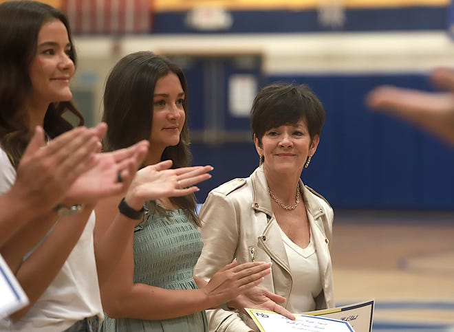 From left, Johanna Myers, Morgan Myers and their mom, Monica Myers honor their father and Monica’s husband, Jim Myers, who is posthumously named to the Burlington Notre Dame Wall of Fame Friday June 10, 2022 at the school in Burlington.