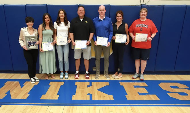 Burlington Notre Dame Wall of Fame honorees are, from left, Monica Myers, for her late husband Jim Myers, Morgan Myers, Johanna Myers, Justin Trine, Jason Trine, Kimberly Trine and Andrea Eaton Friday June 10, 2022 at the school in Burlington.