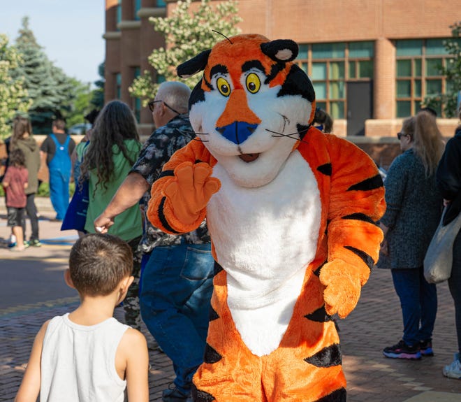 Tony the Tiger greets a boy during the Cereal Fest Saturday, June 11, 2022, in downtown Battle Creek.