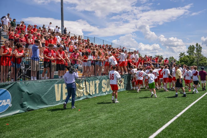 The CVU Redhawks celebrate their 13-11 D1 boys lacrosse championship win with families and fans at UVM's Virtue Field.