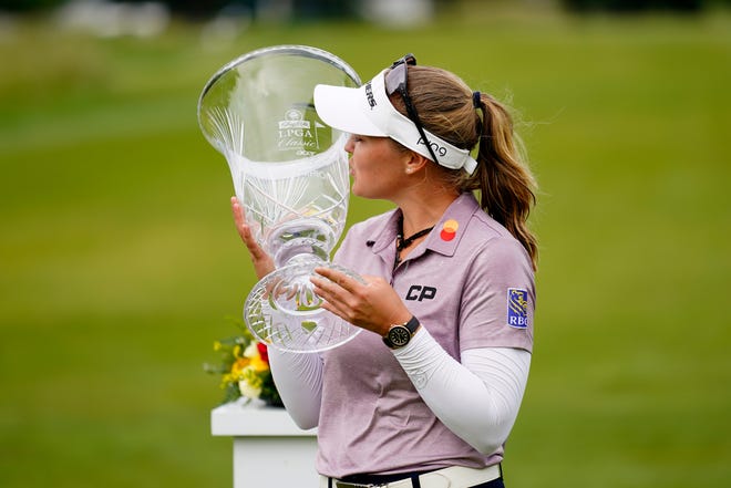 Brooke M. Henderson, of Canada, kisses the trophy after winning the ShopRite LPGA Classic golf tournament, Sunday, June 12, 2022, in Galloway, N.J.