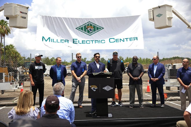 Jaguars owner Shad Khan, center, speaks as the business bearing the name on the new practice facility, Miller Electric Center, is announced during a media conference after a minicamp football practice Monday, June 13, 2022 at TIAA Bank Field in Jacksonville. [Corey Perrine/Florida Times-Union]