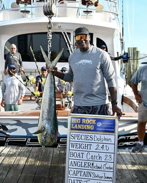Michael Jordan weighs in a dolphin fish Monday at the Big Rock Blue Marlin Tournament.