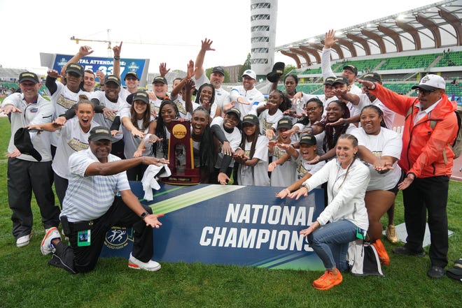 Florida women's team members and coach Mike Holloway celebrate June 11, 2022 after winning the team title during the NCAA Track and Field Championships at Hayward Field in Eugene.  Ore.