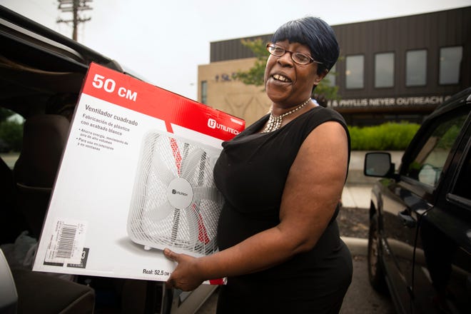 Monique Moye, 50, of Winton Terrace, was all smiles after receiving her fan from Society of St. Vince de Paul, Monday, June 13, 2022. The mother of four said her air conditioning unit in her apartment does not blow cold air. She said both she and her son have asthma, so cooling is very important. Temperatures will be in the 90's this week with a heat index over 100 degrees. Kristen Gallagher, marketing and communications, said since May 1, theyÕve already given out 679 fans and 197 air conditioning units.