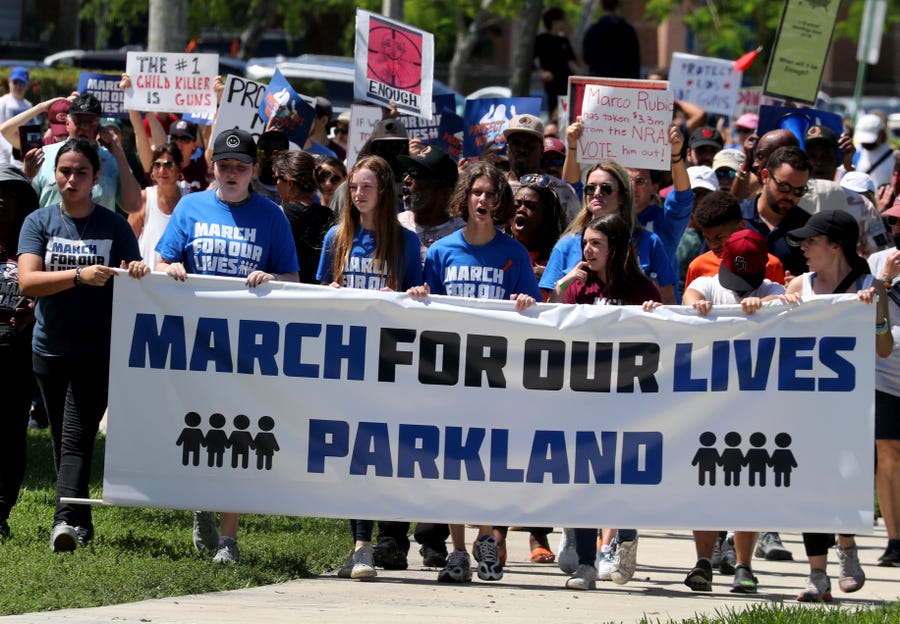 Protesters march during the March For Our Lives Parkland to Demand an End to Gun Violence rally at Pine Trails Park Amphitheater in Parkland, Fla., on Saturday, June 11, 2022. The rally and march coordinated with over 400 marches nationwide. (Mike Stocker/South Florida Sun-Sentinel via AP) ORG XMIT: FLLAU702