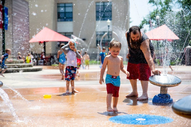 The fenced-in play area at Zeeland Splash Pad offers restrooms, benches, tables and shade, and is located near food and drink options in downtown Zeeland.