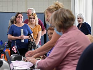 Voters wait in line to vote during the primary elections at the Sparks library on June 14, 2022.