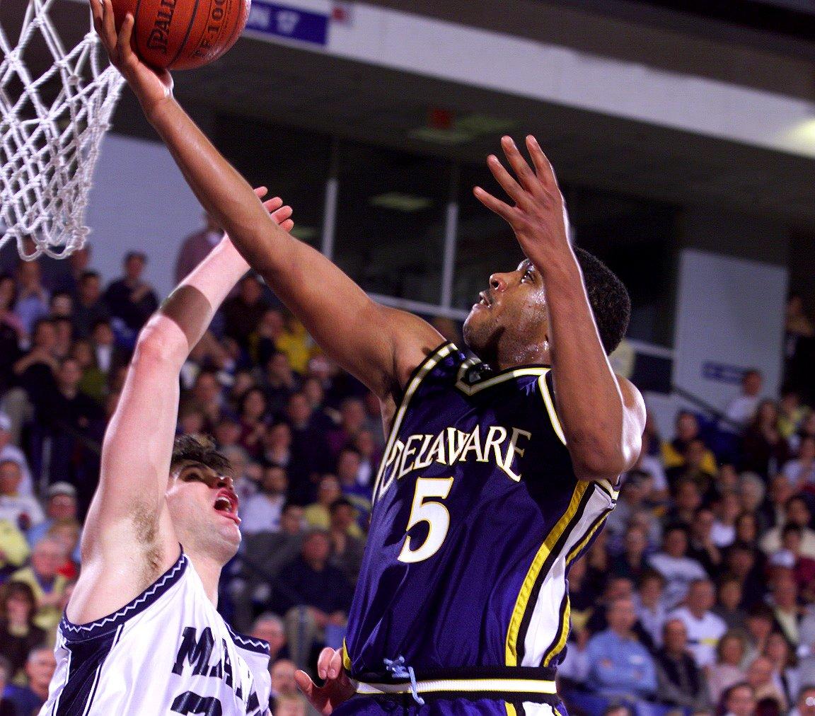 Mike Pegues drives for a layup over Maine's Nate Fox.