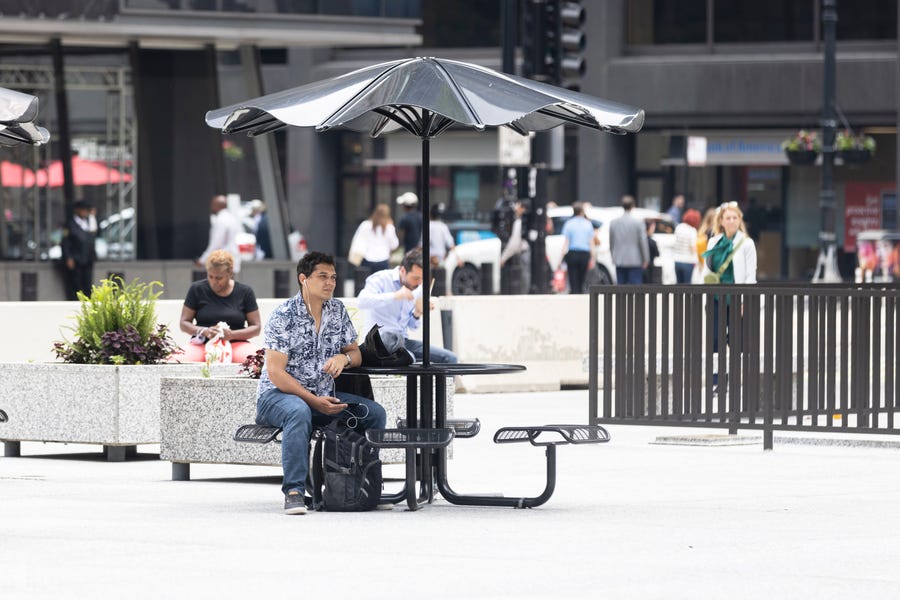 A person sits at a table at Daley Plaza in the loop, Monday, June 13, 2022, in Chicago.