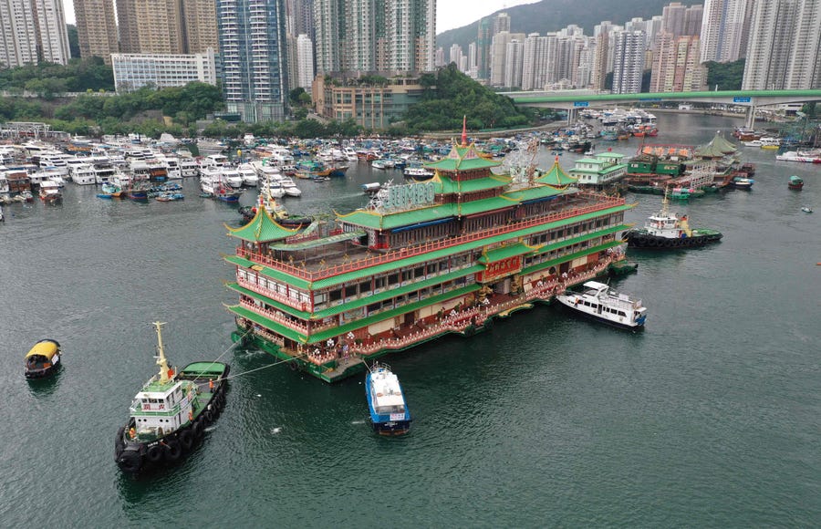 An aerial photo shows Hong Kong's Jumbo Floating Restaurant, an iconic but aging tourist attraction designed like a Chinese imperial palace, being towed out of Aberdeen Harbour.