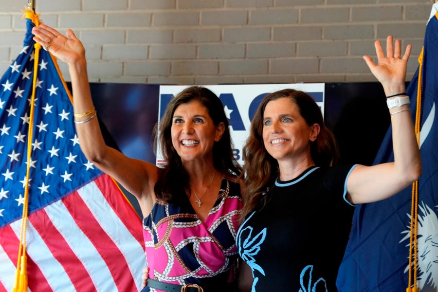 Former South Carolina Gov. Nikki Haley, left, cheers alongside U.S. Rep. Nancy Mace, right, during a campaign rally ahead of of South Carolina's GOP primary elections on Sunday, June 12, 2022, in Summerville, South Carolina.