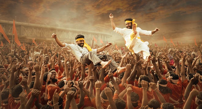 Ram Charan (left) and NT Rama Rao Jr. play brothers in arms and revolutionaries in the Indian action-epic musical "RRR."