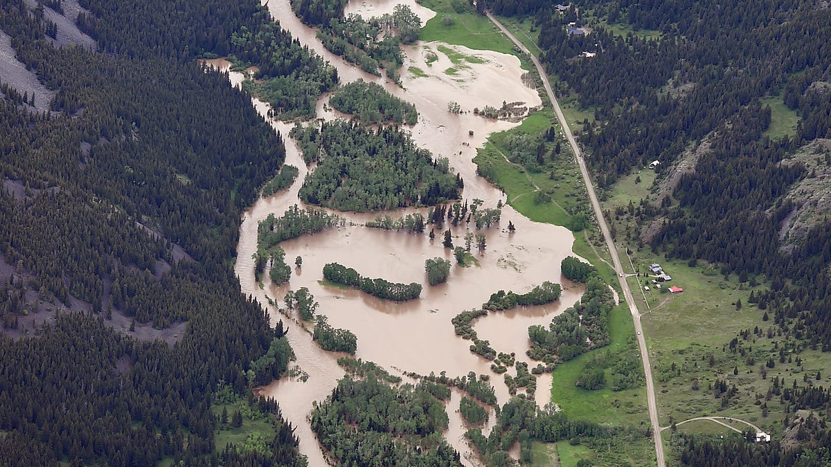 The Boulder River south of Big Timber floods roads and homes on Monday, June 13, 2022, as major flooding swept away at least one bridge, washed away roads and set off mudslides in Yellowstone National Park in Montana. 