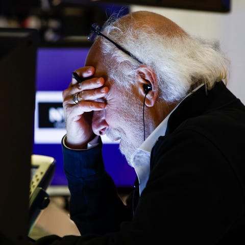 Trader Peter Tuchman reacts as he works on the flo