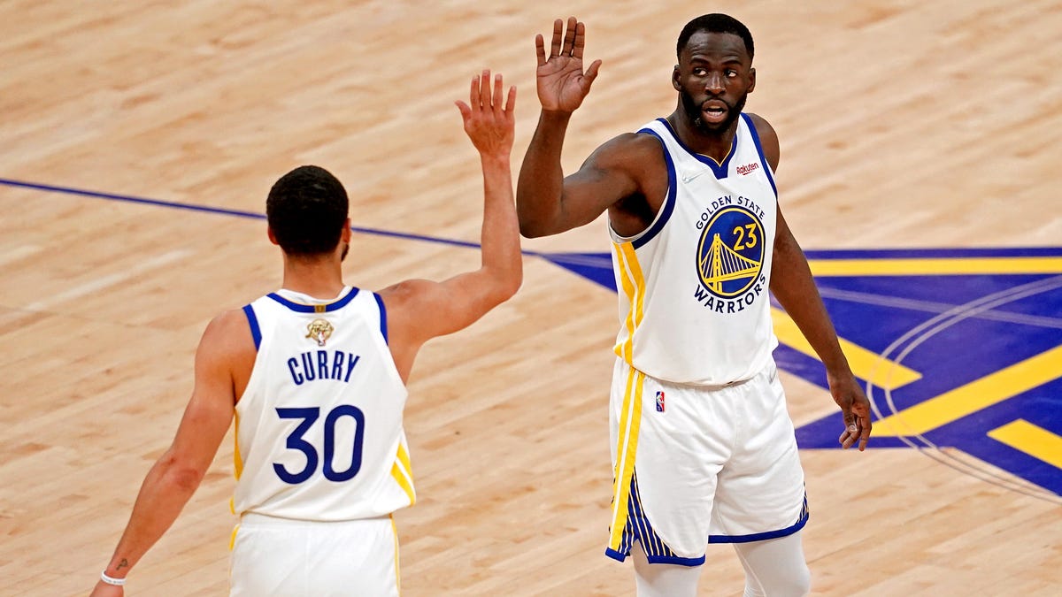 Steph Curry celebrates a first-half bucket with Draymond Green.