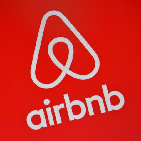 Airbnb's logo is displayed on a computer screen in