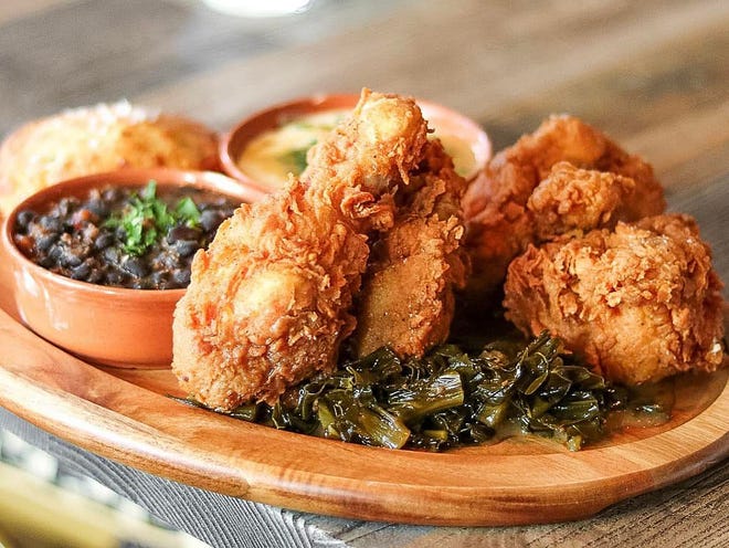 Through at least August, Buccan's summertime-only fried chicken is served with BBQ baked beans, collards and cheddar-scallion biscuits.