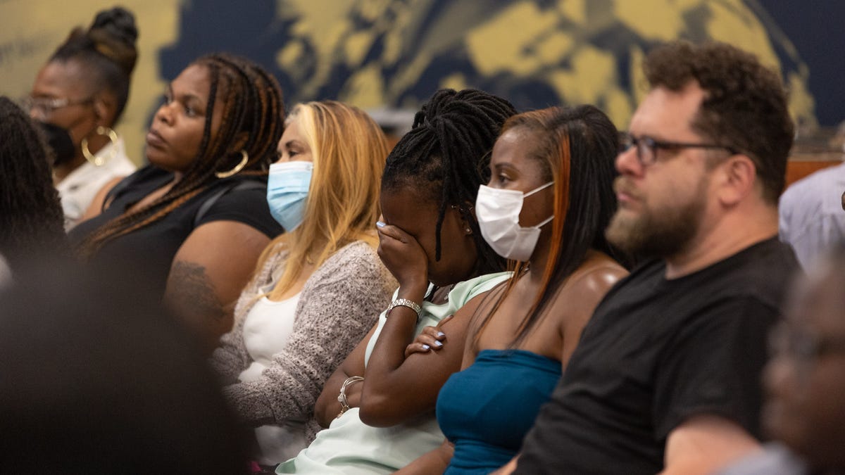 Tanika McCullough puts her hand on her head at a Newburgh school board meeting in Newburgh, NY on June 14, 2022.