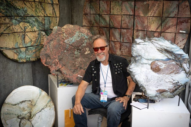 Tuscarawas County artist Tom Radca is shown with some of his work at the Columbus Art Festival.