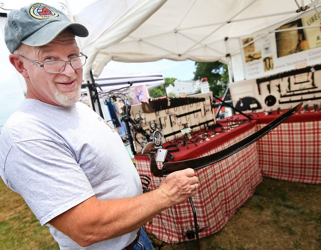 John Liberty of Liberty Farm and Forge shows some of his metal garden art designs at the 2016 York Days Craft Fair.