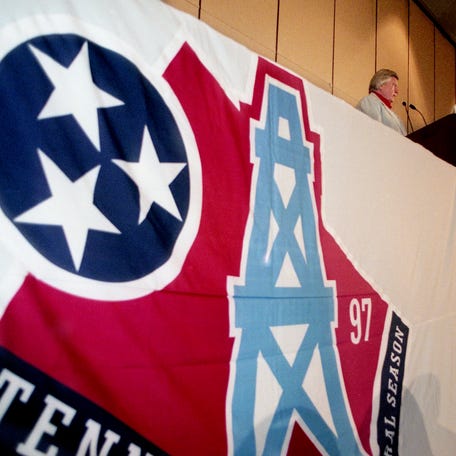 Former Houston Oilers and now Tennessee Oilers owner Bud Adams shows off the new logo that will appear on team jerseys and the back of players' helmets during a press conference at Loews Vanderbilt Plaza June 12, 1997.