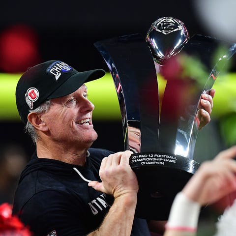 Kyle Whittingham holds up the Pac-12 championship 