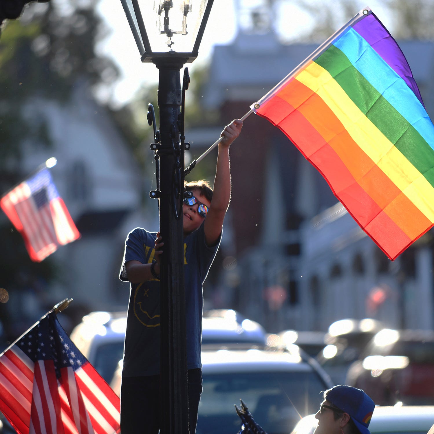 Families took part in the changing of the downtown Nevada City flags along Broad Street, Commercial Street, and Union Alley where the Pride flag is displayed for the month of June and Pride month, Tuesday, May 31, 2022.