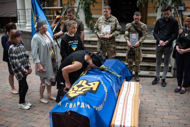 Svitlana Nazarenko, sister of Mykhailo Tereshchenko, cries over his coffin Tuesday in Kyiv, Ukraine.  Mykhailo Tereschchenko, 50, was a Ukrainian soldier who was killed in the Ukrainian region of Donbas.  (Photo by Alexey Furman/Getty Images)
