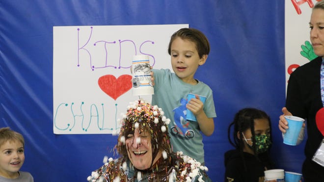 New Hope Elementary School students make a "human sundae" out of Principal Lynn Whiteside after raising more than $15,000 for the American Heart Association.