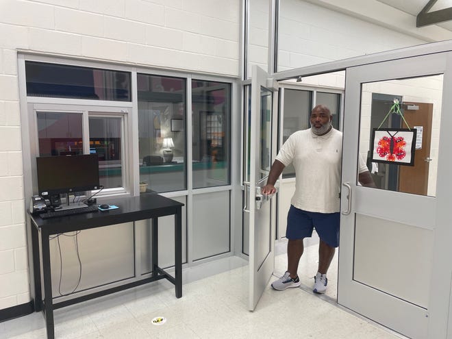 Curtis White, behavioral specialist at Hillcrest Elementary School, at the school's new security door and kiosk.