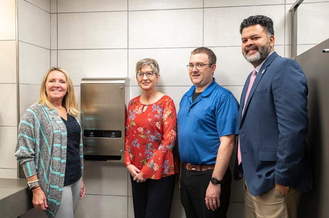 Charitable Union CEO Teresa Allen, left, KCC Foundation Executive Director Teresa Durham, KCC Director of Institutional Facilities Brad Fuller and KCC interim President Paul Watson II showcase one of the college's new, hands-free menstrual product dispensers.