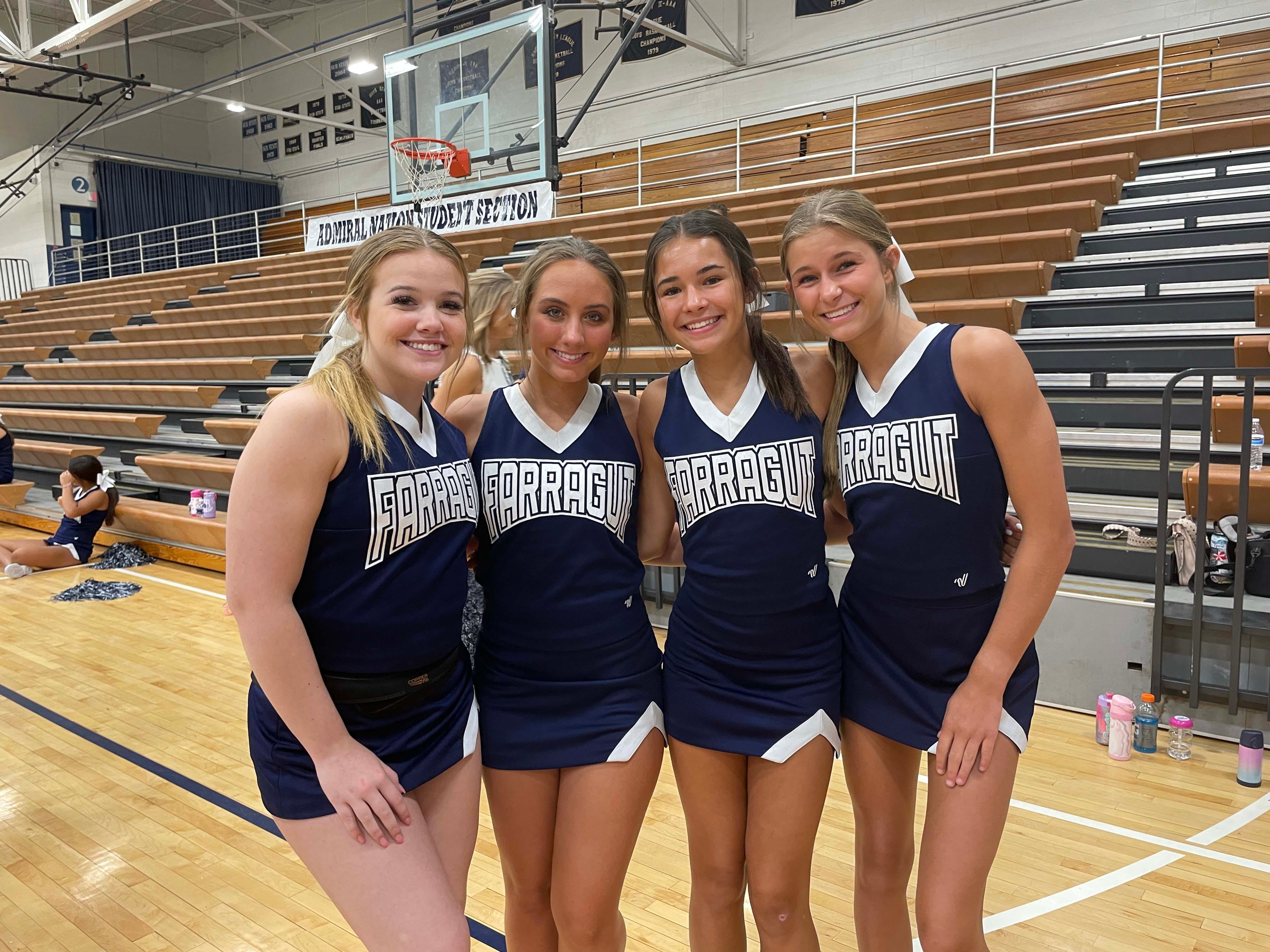 Farragut High School cheerleaders Alex Kate, 16, Reese Higdon, 17, Nicole Kulisek, 14, and Loryn Good, 15, take a break from the organized chaos at a cheerleading camp held at the school Wednesday, June 15, 2022.