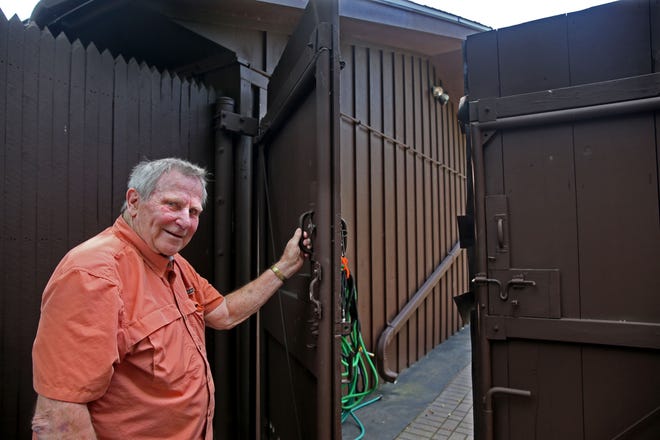 The gate leading to Bud Wiggin's backyard at his home in Menomonee Falls is over 7 feet tall.