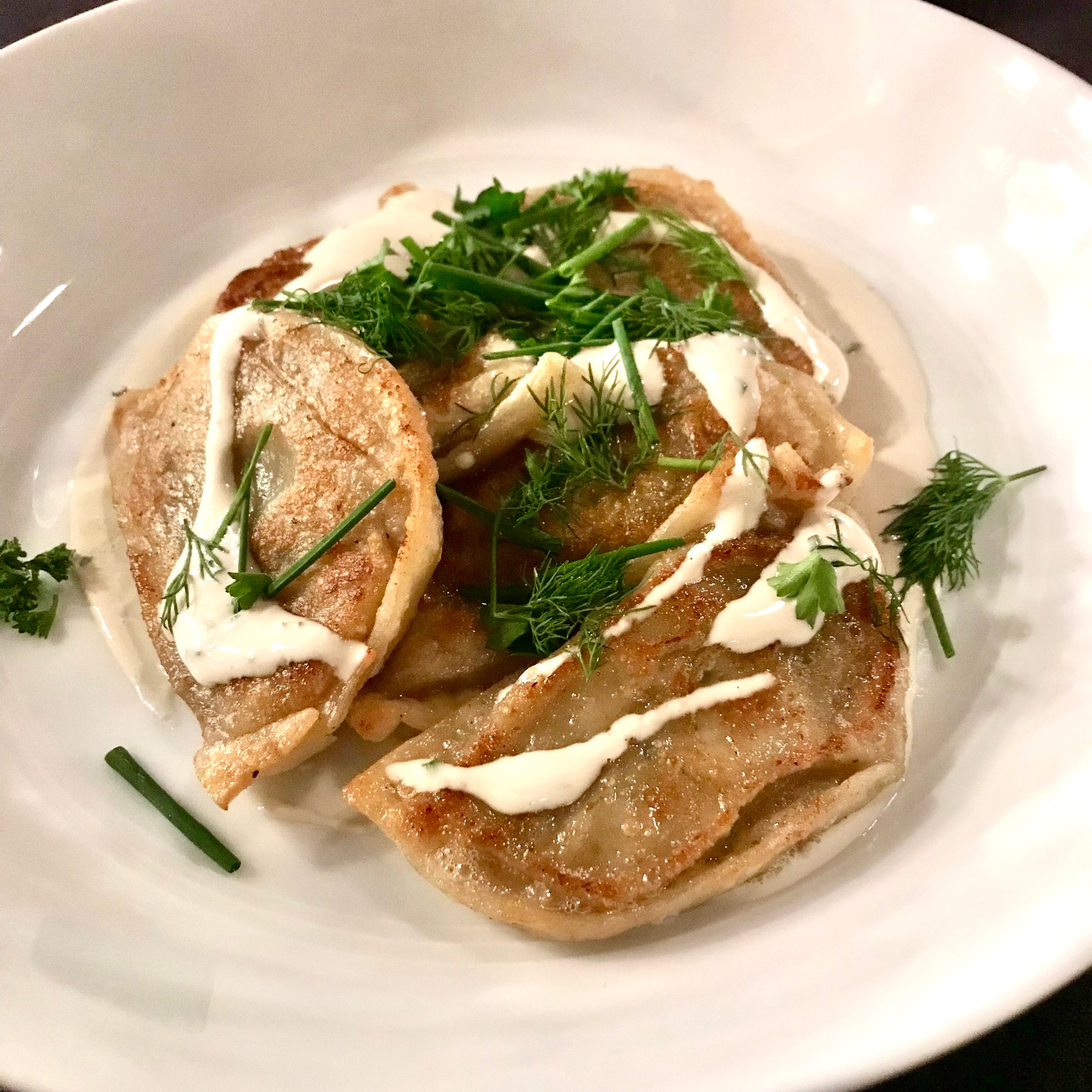 Potato pierogi with fresh herbs and sour cream is one of the small plates at Fool's Errand in the Third Ward.