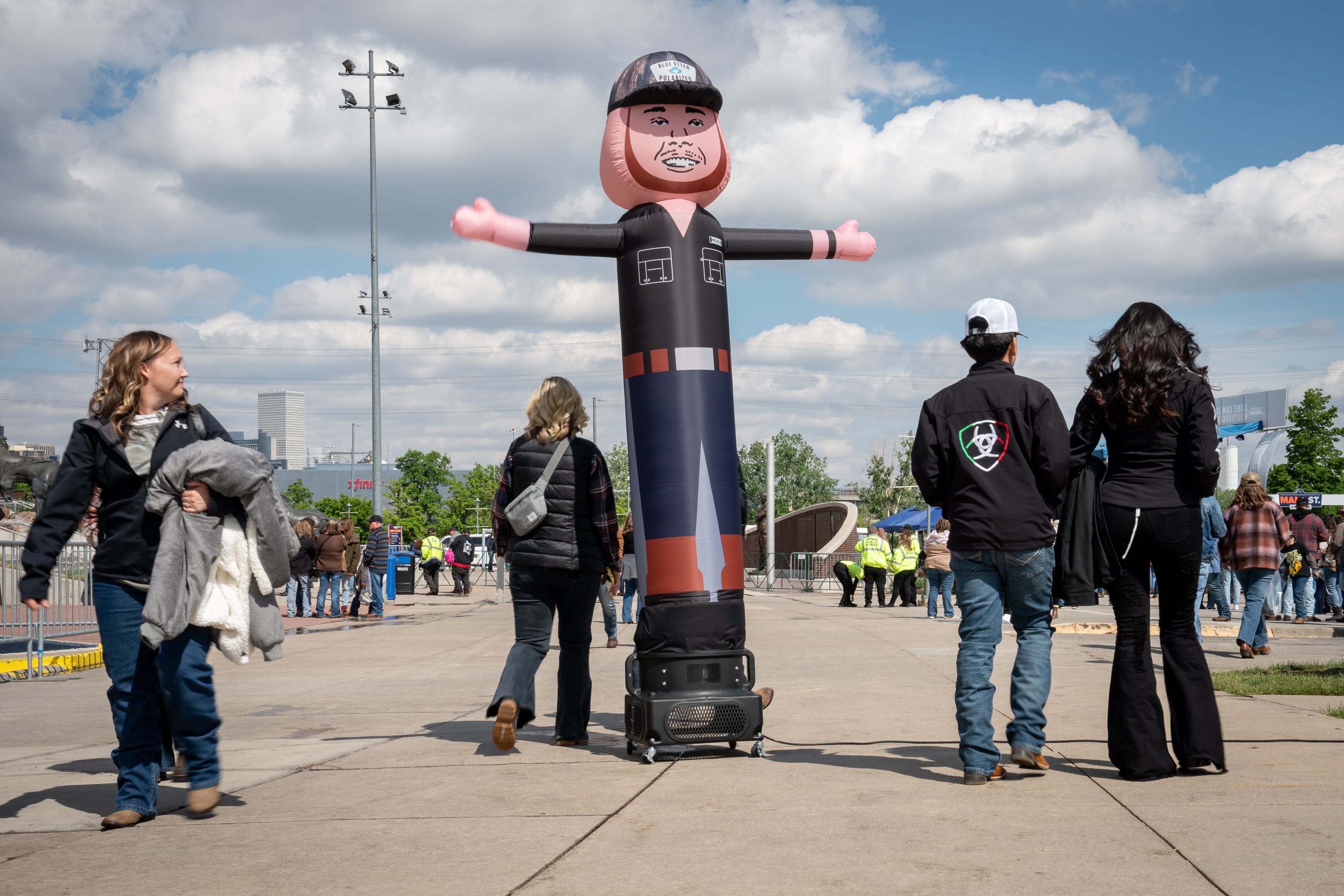 Fans walk past an inflatable Luke Combs before his concert at Empower Field at Mile High in Denver, Colo., Saturday, May 21, 2022. The show kicked off Combs’ first-ever headlining stadium tour.