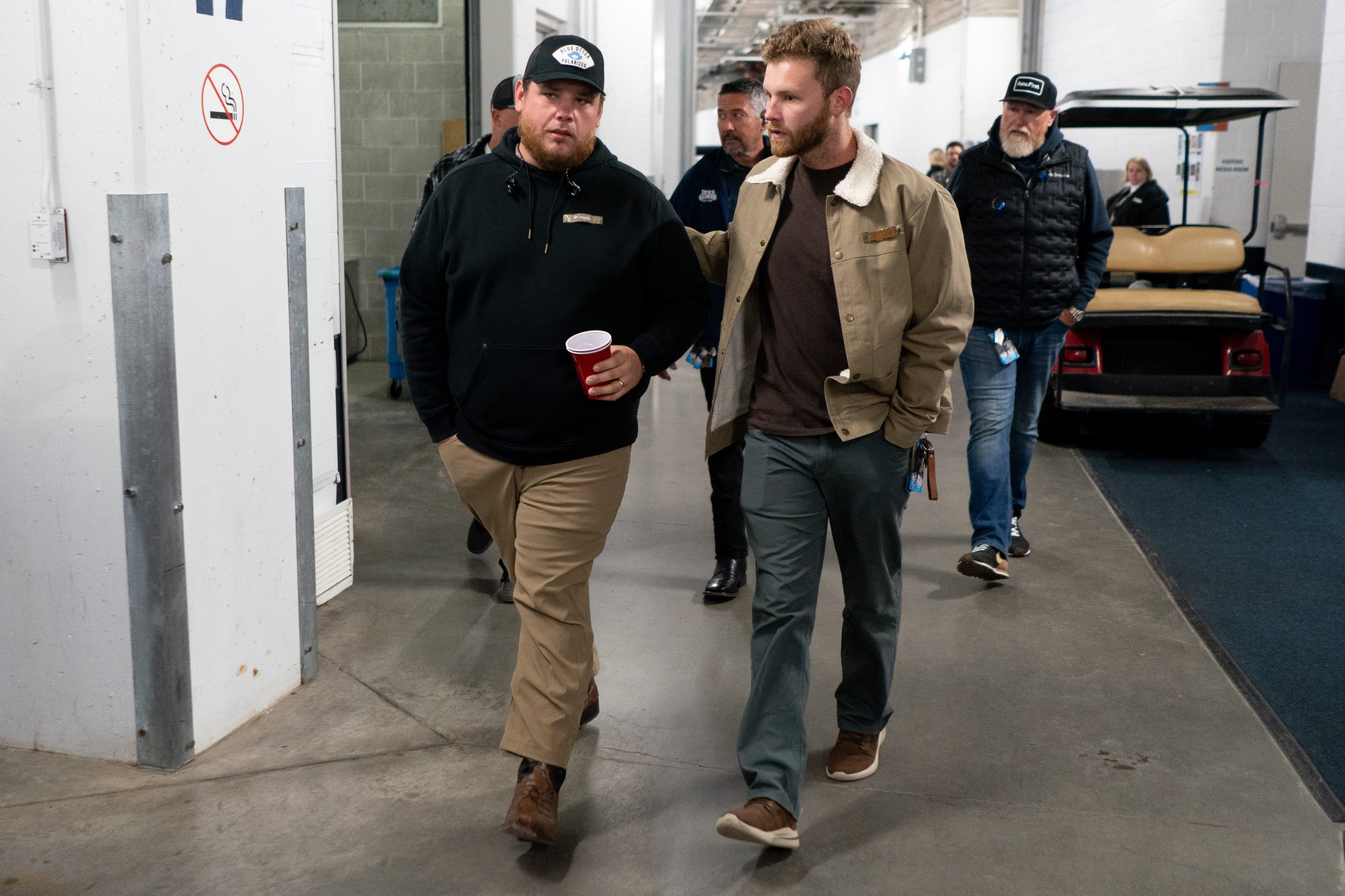 Luke Combs, left, chats with tour manager Ethan Strunk, right, before performing at Empower Field at Mile High in Denver, Colo., Saturday, May 21, 2022. The show kicked off Combs’ first-ever headlining stadium tour.