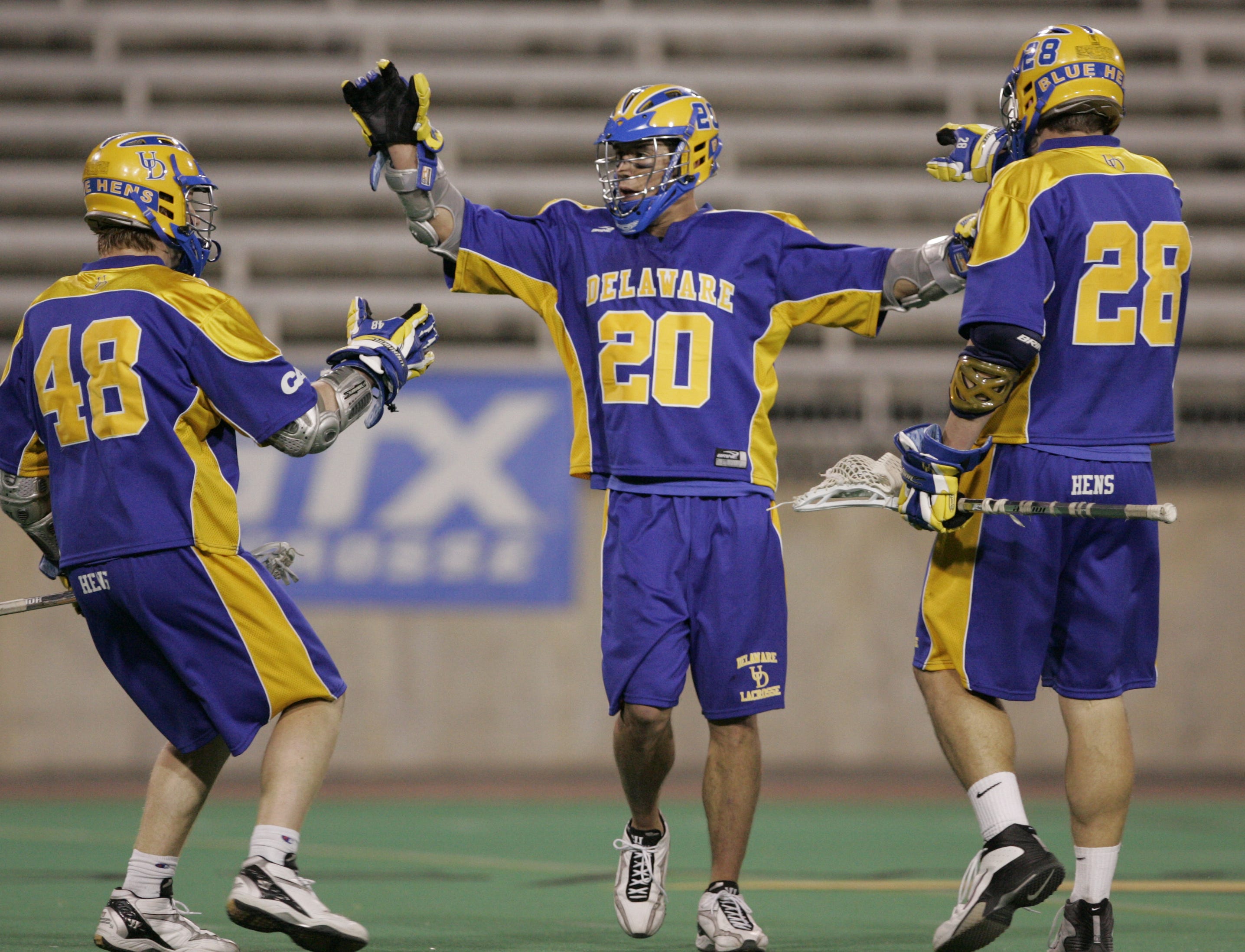 The University of Delaware's Jordan Hall (20) celebrates his fourth quarter goal with teammates Curtis Dickson (48) and J.J. Moran in the Blue Hens' Colonial Athletic Association title game win over Towson, 10-7, at Johnny Unitas Stadium in Towson, Maryland, Saturday, May 5, 2007.