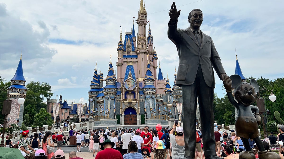 Guests gather for a performance in front of Cinderella Castle at Walt Disney World's Magic Kingdom.