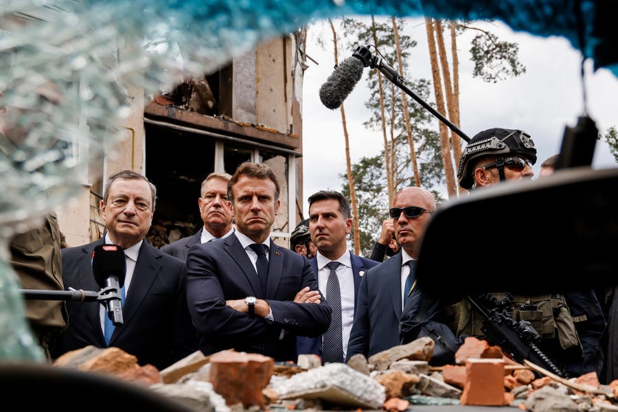 Italian Prime Minister Mario Draghi, left, and French President Emmanuel Macron watch debris as they visit Irpin, outside Kyiv, Thursday, June 16, 2022. The leaders of France, Germany, Italy and Romania arrived in Kyiv on Thursday in a show of collective European support for the Ukrainian people as they resist Russia's invasion, marking the highest-profile visit to Ukraine's capital since Russia invaded its neighbor.