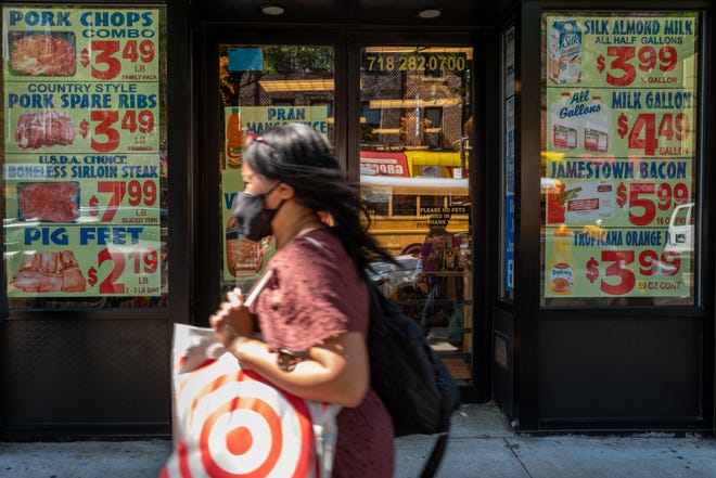 Prices are advertised outside of a grocery store along a busy shopping street in the Flatbush neighborhood of Brooklyn on June 15, 2022 in New York City.