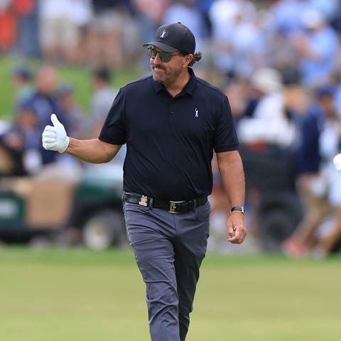 Phil Mickelson acknowledges the crowd as he walks 